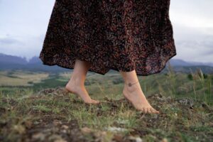 A woman simultaneously practicing walking meditation and grounding