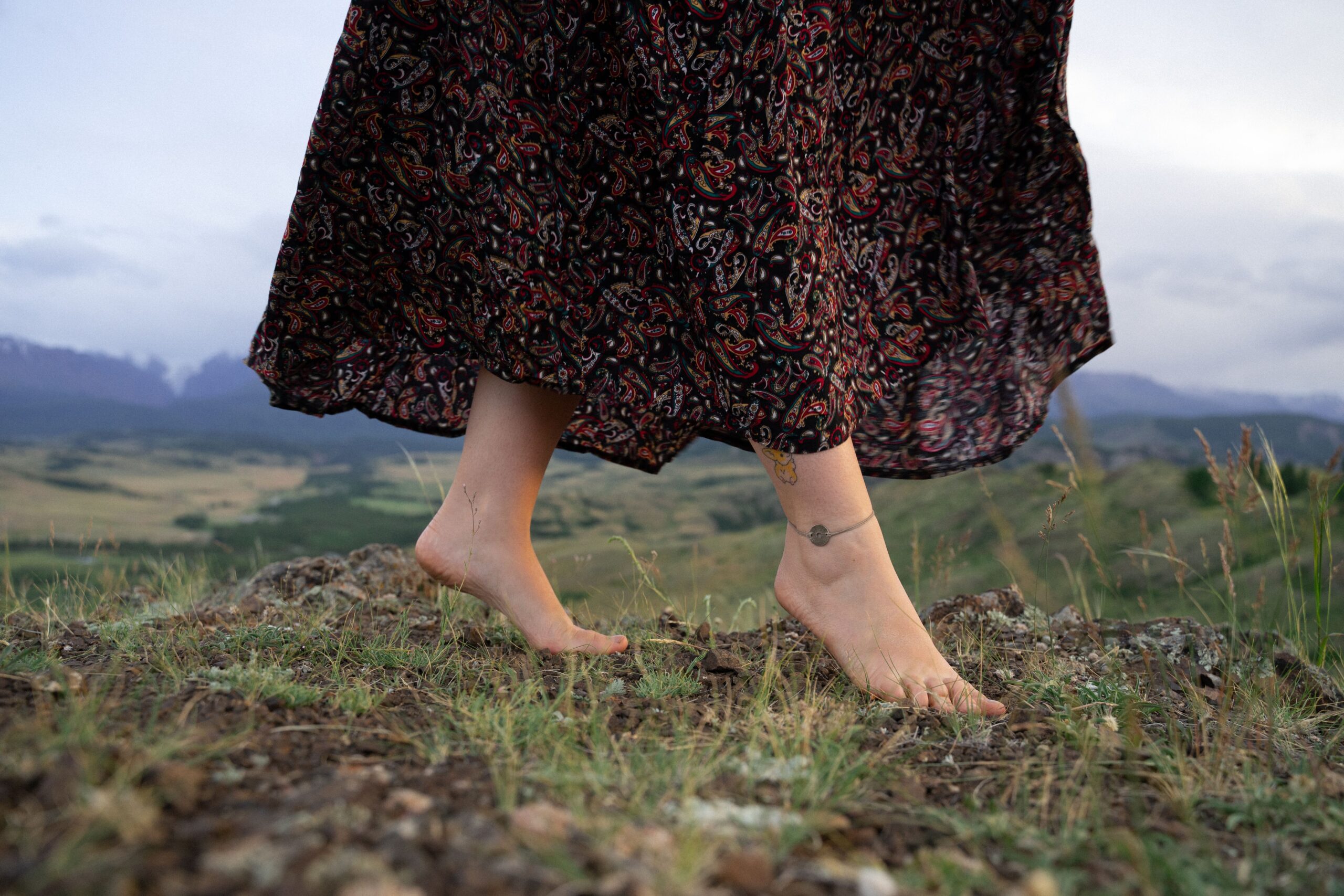 A woman simultaneously practicing walking meditation and grounding